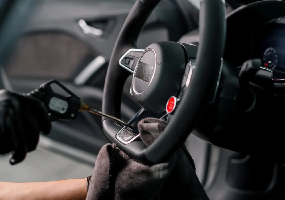 a-mechanic-in-gloves-cleans-the-steering-wheel-wit-2023-12-27-18-24-14-utc