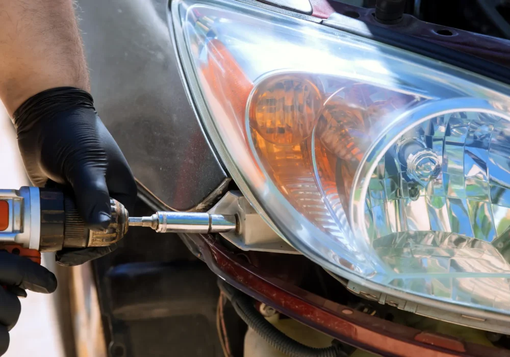 while-repairing-car-repairman-installs-a-headligh-2023-12-15-00-25-38-utc